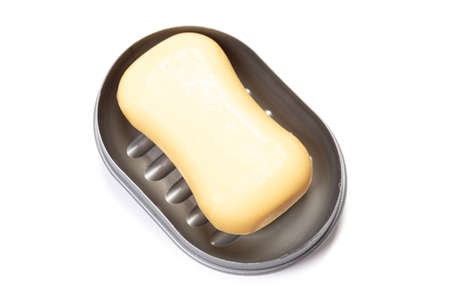 Soap in PLASTIC COLORED soap dish isolated on white backgroundの写真素材