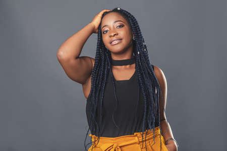 portrait of a young woman of ethnic African appearance. She looks at the camera and smiles, curly...