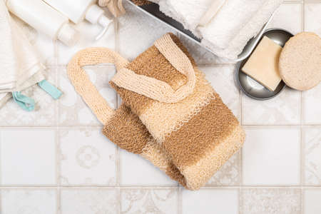 natural materials for bathroom accessories. bath sponges, washcloths, soap and towels on a light background.の写真素材