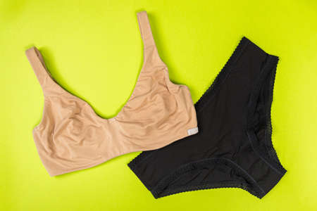 top view of fashionable bra and panties set on green background Female wardrobe, shopping concept. Underwear.の写真素材