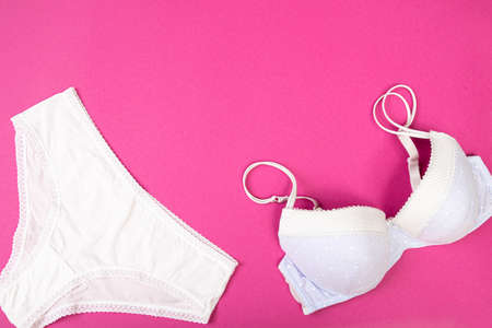 fashionable bra with panties on a pink background with copy space. Women's wardrobe, shopping concept. Underwear.の写真素材