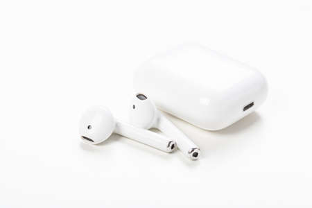 Modern wireless earphones with charging case on a white background. The concept of modern...