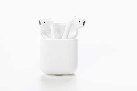 Modern wireless headphones with charging case on a white background. The concept of modern...