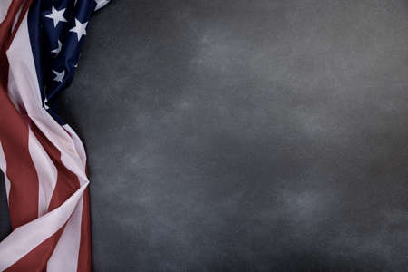 Close up of ruffled American flag on dark background. Satin texture curved flag of USA. Memorial Day or 4th of July. Banner, freedom conceptの写真素材
