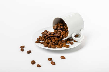 Perfect small white coffee cup with roasted coffee beans on white backgroundの写真素材