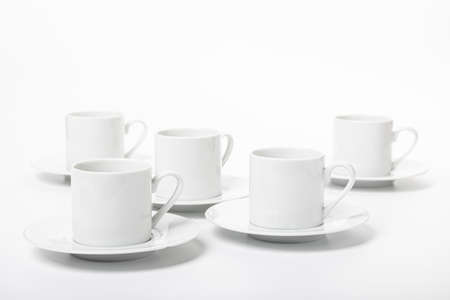 several white porcelain cup and saucer for coffee isolated on white backgroundの写真素材
