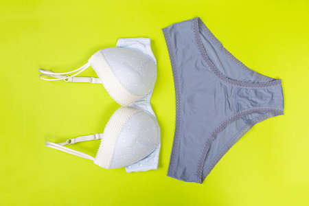 top view of fashionable bra and panties set on green background Female wardrobe, shopping concept. Underwear.の写真素材