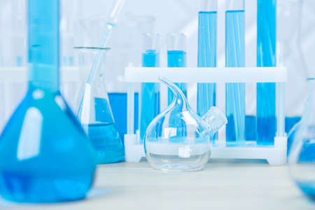 Laboratory glassware with blue liquid in a test tube. scientific laboratory flasks, droppers, Petri...