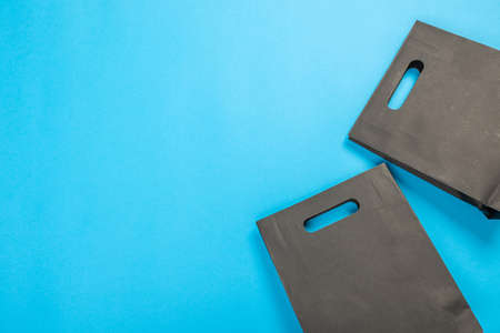 Eco-friendly recyclable paper gift bag with handles on blue backgroundの写真素材