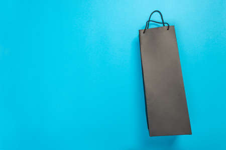 Eco-friendly recyclable paper gift bag with handles on blue backgroundの写真素材