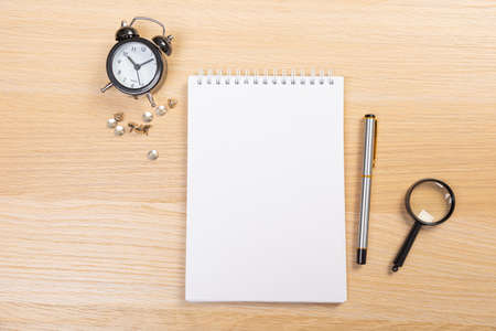 Working table with keyboard and notepad, pen, pencil and plant in home office. top viewの写真素材