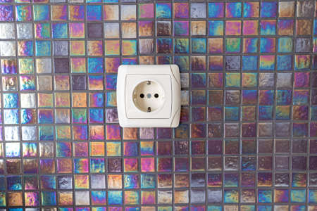 white socket on empty kitchen wall near work surfaceの写真素材