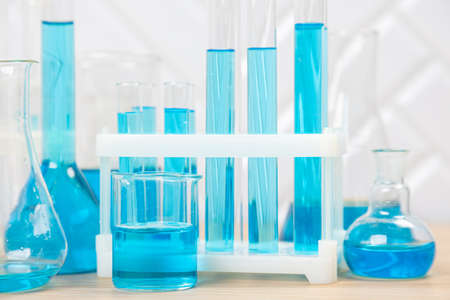 Laboratory glassware with blue liquid in a test tube. scientific laboratory flasks, droppers, Petri...