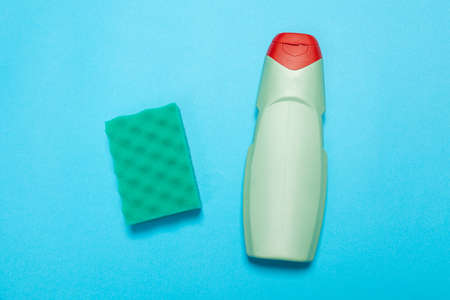 Detergent for various surfaces and a rag on a blue background. Professional cleaning products, general cleaning. Household chemicalsの写真素材