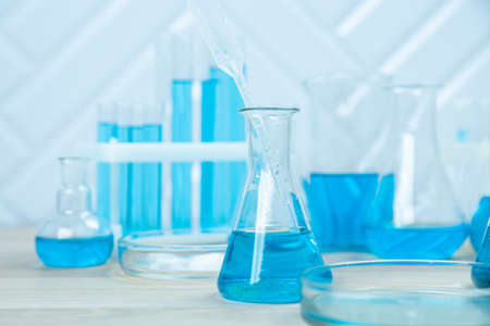 Laboratory glassware with test tubes. flasks, dropper, petri dishes, measuring cups and cylinders for scientific laboratories, laboratory equipment and analysisの写真素材