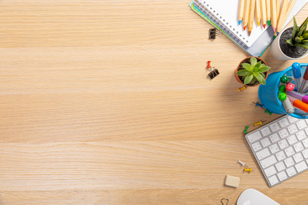 Wooden office table with laptop, coffee cup and supplies. Top view with copy space, flat lay.の写真素材