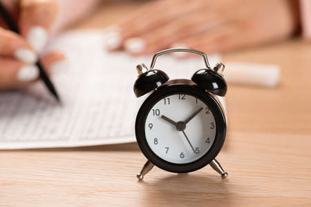 alarm clock for a student writing exams, taking an exam room with a pencil holding on an optical...