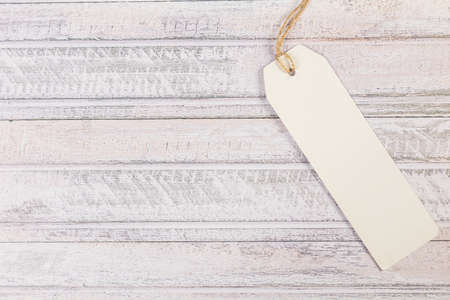 white Blank tag on a wooden backgroundの写真素材