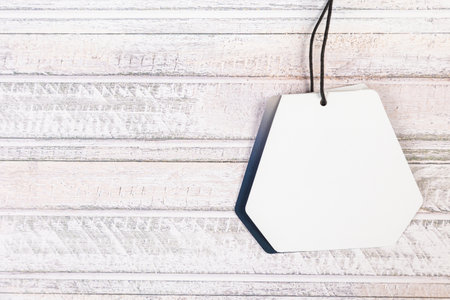 white Blank tag on a wooden backgroundの写真素材