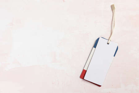 Clothing tag, label blank mockup template on pink tableの写真素材