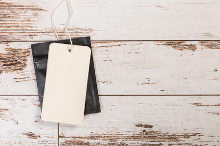 white Blank tag on a wooden backgroundの写真素材