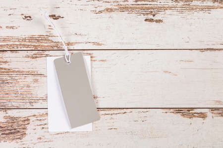 white Blank tag on a wooden backgroundの写真素材
