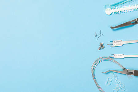a set of special tools for an orthodontist to install braces for a patient. Orthodontic arcs, ligature, locks, positioner, tweezers, rubber bandsの写真素材