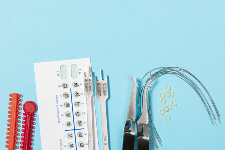 a set of special tools for an orthodontist to install braces for a patient. Orthodontic arcs, ligature, locks, positioner, tweezers, rubber bandsの写真素材