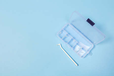 orthodontic toothbrush with one bundle for braces on a blue backgroundの写真素材