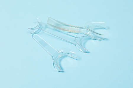 set of several Retractor Dental lip retractor Access to the oral cavity. Wide mouth opening for a dental procedure on a blue backgroundの写真素材