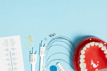 a set of special tools for an orthodontist to install braces for a patient. Orthodontic arcs, ligature, locks, positioner, tweezers, rubber bandsの写真素材