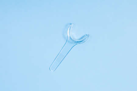 Retractor Dental lip retractor Access to the oral cavity. Wide mouth opening for a dental procedure on blueの写真素材