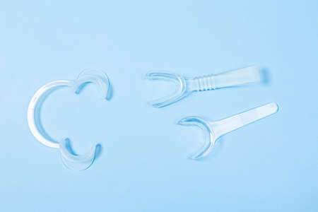 set of several Retractor Dental lip retractor Access to the oral cavity. Wide mouth opening for a dental procedure on a blue backgroundの写真素材