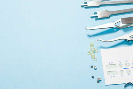 a set of special tools for an orthodontist to install braces for a patient. Orthodontic arcs, ligature, locks, positioner, tweezers, rubber bandsの写真素材
