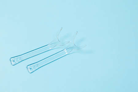 set of several Retractor Dental lip retractor Access to the oral cavity. Wide mouth opening for a dental procedure on a blue backgroundの写真素材