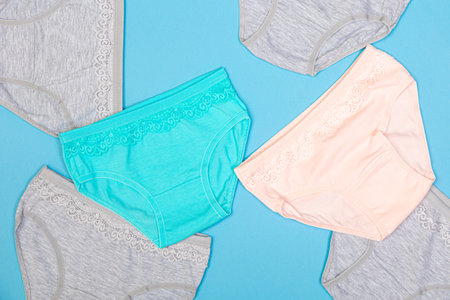 Clothes for children in the form of panties on a blue background. Clothes for children from soft...