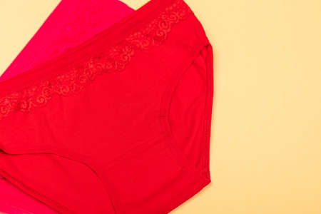 Clothing for children in the form of panties. Clothes for children from soft fabric. panties for girls. A set of panties for children. view from above. Underwear set. Set of underwear on a yellow backgroundの写真素材