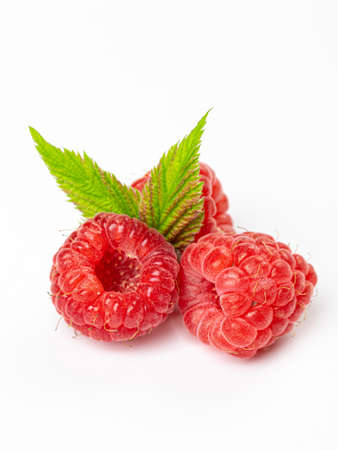 Isolated berries. Bunch of raspberry fruits with leaves isolated on white background with clipping pathの写真素材