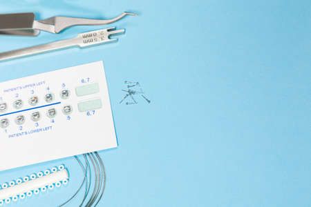 a set of special tools for an orthodontist to install braces for a patient. Orthodontic arcs,...