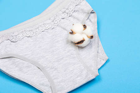 Clothes for children in the form of panties on a blue background. Clothes for children from soft fabric. panties for girls.の写真素材