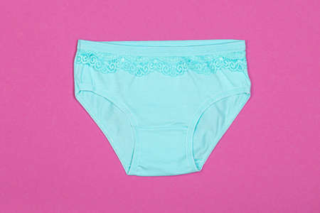 Clothes for children in the form of panties on a pink background. Clothes for children from soft fabric. panties for girls. view from above.の写真素材