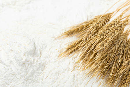 Close-up of a heap of flour and ears of wheat after sifting. Concept Record prices and high prices for bakery products. Rising wheat prices in Europe.の写真素材