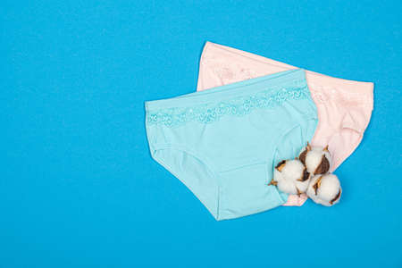 Clothing for children in the form of panties. Clothes for children from soft fabric. panties for girls. A set of panties for children. view from above. Underwear set. Underwear set. on a blue backgroundの写真素材