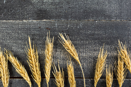 Wheat Ears on the Wooden Table. Sheaf of Wheat over Wood Background. harvest conceptの写真素材
