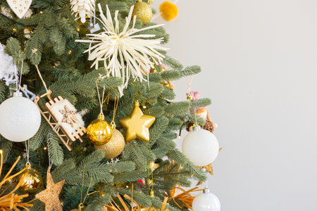 Christmas tree decorated with golden ball toys on a blurry, sparkling and fabulous fairy tale background with beautiful bokeh, copy space.の写真素材