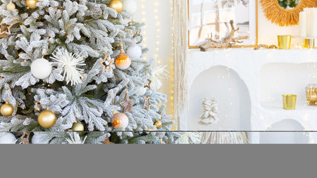 Christmas tree decorated with golden ball toys on a blurry, sparkling and fabulous fairy tale background with beautiful bokeh, copy space.の写真素材