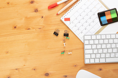 Calendar and agenda reminders, work from home online. desktop calendar with stationery and pen pencil, keyboard. mark a holiday trip or plans in a diary at the office desk. 2023 calendar reminder concept.の写真素材