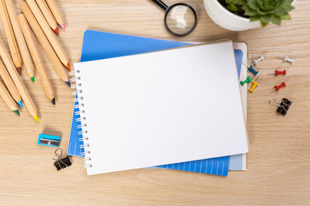 Back to school concept. Top view photo of notepads, pens, sharpeners, ruler, staplers, clips, markers and erasers on wooden tableの写真素材