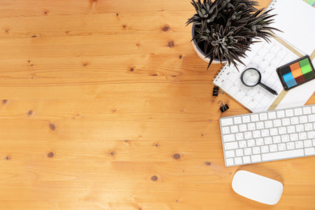 Calendar and reminders with magnifying glass, work from home online. glider on desktop with mouse and pen, keyboard. mark a holiday trip or plans in a diary at the office desk. 2023 calendar reminder concept.の写真素材