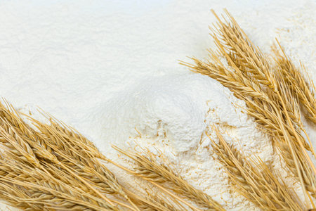 Close-up of a heap of flour and ears of wheat after sifting. Concept Record prices and high prices for bakery products. Rising wheat prices in Europe.の写真素材